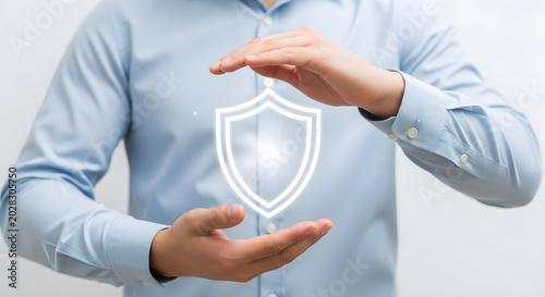Man hands protecting a glowing shield symbol, symbolizing security and protection.