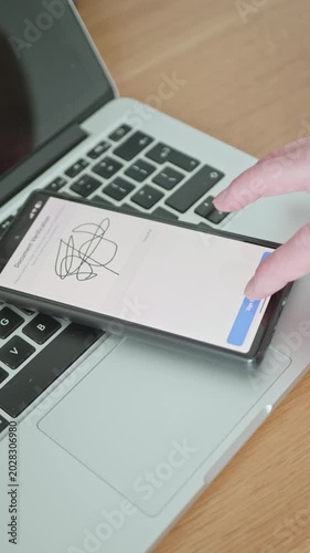 Digital signature and document verification process on a mobile phone display. Paperless business transaction concept.