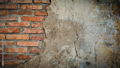 Photos Exposed Brick Wall with Cracked Plaster and Weathered Texture