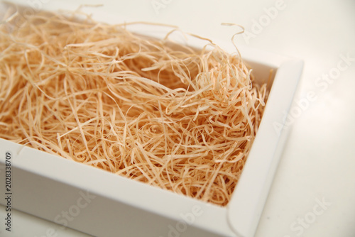 Tableau sur toile White box filled with wooden excelsior cushioning material