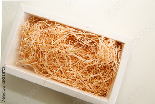 Schilderij op canvas White box filled with wooden excelsior cushioning material