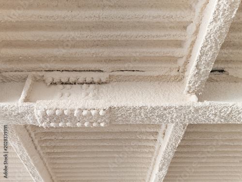 Bild auf Leinwand Close-up photograph of spray-applied fireproofing insulation on industrial steel