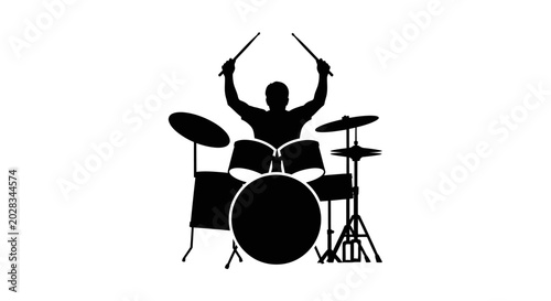 Drummer playing drum set enthusiastically alone.