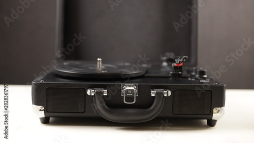 Photos Vintage portable record player with built-in speakers and carrying handle