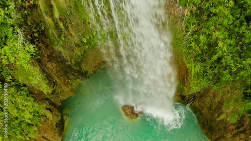 Beautiful waterfall in green forest, top view. Tropical Inambakan Falls in mountain jungle, Philippines, Cebu. Waterfall in the tropical forest.