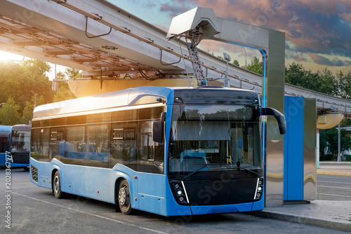 Bus at a charging station has its pantograph connected to a high voltage connector at the final stop of the route.