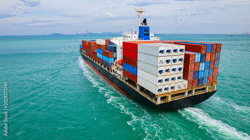 Canvastavla Cargo ships, carrying containers of goods, set sail at sea to deliver the goods to their destination