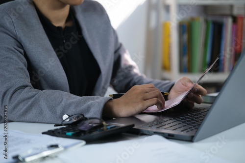 Photos Viewing Bank Account Book in front of laptop, Account Statement, Money Number, C