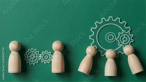 Wooden figures align with gears symbolizing teamwork and mechanical