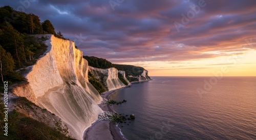 White chalk cliffs at sunset overlooking the sea.
