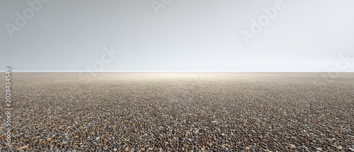 Minimalist pebble plain with distant horizon and clear sky