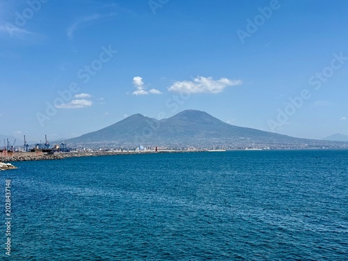 Beautiful panoramic landscape of Mount Vesuvius over the blue Mediterranean sea in Naples
