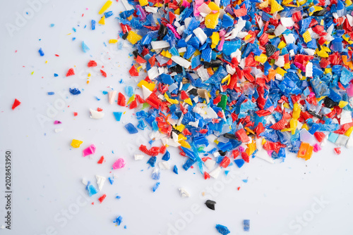 Fotografie Plastic colorful pieces recycling shredded for industrial use.