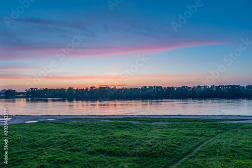 Springtime landscape with river at twilight.