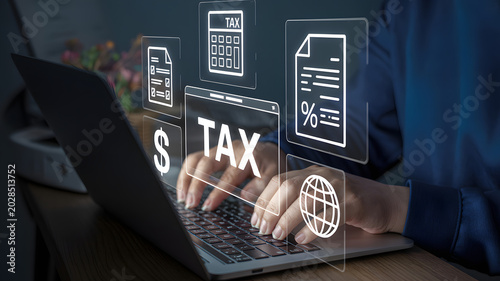 Person working on laptop with tax preparation icons floating above keyboard and screen