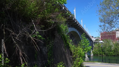 Beautiful Arched bridge crossing peaceful southern river in Fairmont, West Virginia on summer day 