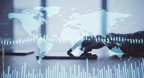 Businessman hand working on digital tablet with world map hologram and financial graph, data analysis and global business concept