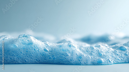 Blue soapy foam bubbling across flat surface close up