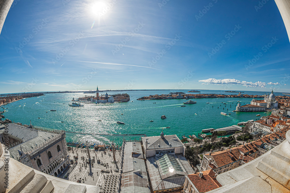 Fototapeta premium VENICE, ITALY - MARCH 16, 2023: Venice panorama South-East from the height of Campanile San Marco tower, with Piazzetta San Marco in foreground, sea and venetian island in background.