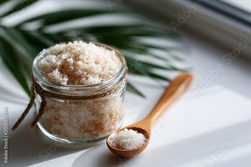 Homemade body scrub in a jar with wooden spoon