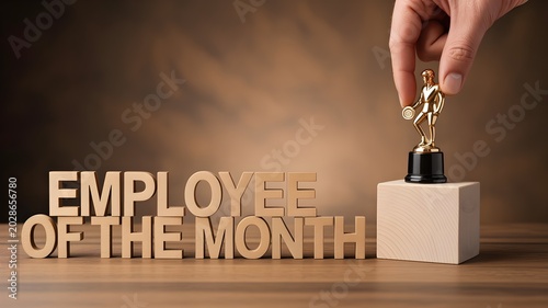 Hand placing golden employee of the month trophy on wooden block next to 3d text