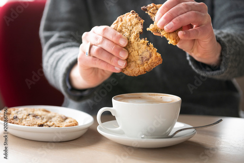 Tableau sur toile Enjoying a Warm Chocolate Chip Cookie With a Steaming Cup of Coffee