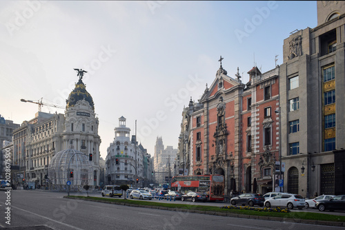 Fotografie Gran Via and Metropolis Building in Madrid Spain at Sunset