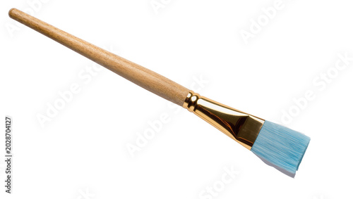 Tableau sur toile Flat paintbrush with wooden handle and golden ferrule light blue bristles, isola