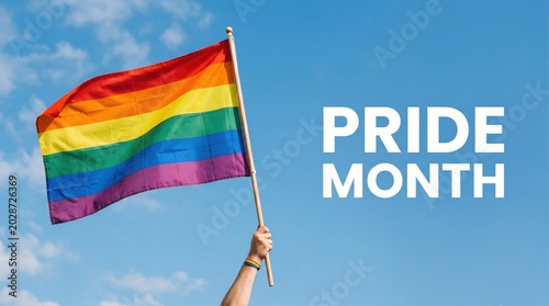 Rainbow pride flag waving in blue sky, LGBTQ pride month celebration banner, person holding colorful pride flag for equality and diversity
