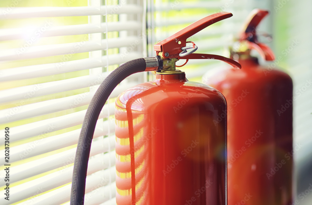 Obraz premium Fire extinguisher has hand engineer inspection checking pressure gauges to prepare fire equipment for protection and prevent emergency and safety rescue and alarm system training concept.