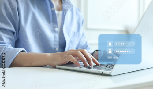 close up man hand type on laptop to access account on website by input username and password at office for security system of business technology concept