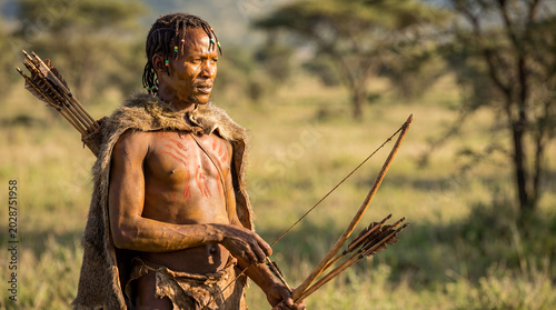 Tanzanian Hadzabe hunter man traditional bushcraft East African indigenous hunter gatherer portrait ancient tribal culture authentic heritage survival identity nomadic proud Rift Valley ethnic male