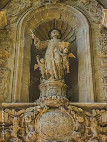 Manresa, Spain - October 1, 2025: Sculptural stone detail at the Sanctuary of the Cave of Saint Ignatius in Manresa, Catalonia, Spain. Historic religious ornamentation illuminated by warm sunlight.