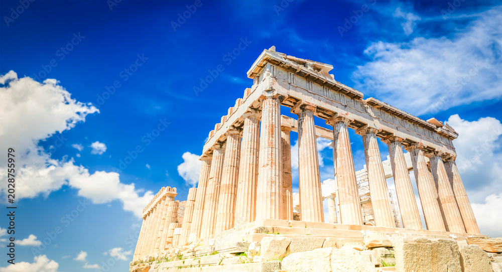 Fototapeta premium Parthenon temple over bright blue sky background, Acropolis hill, Athens Greece, web banner format