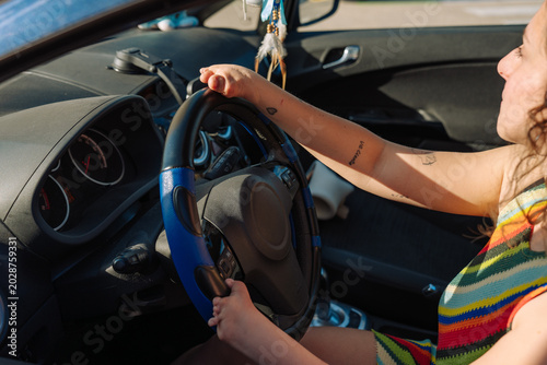 Photography Young woman confidently driving car with malformation hands