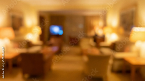 Blurred cozy living room interior with warm lamps and inviting furniture
