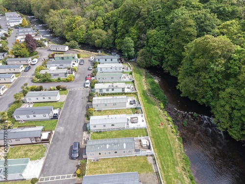 Aerial perspective of holiday caravan area with open grassy terrain and warm seasonal light