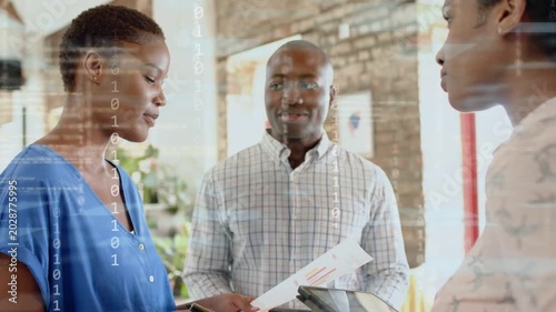 Woman in blue in business reading paper aloud code layer passing sheet while signing team reviewing