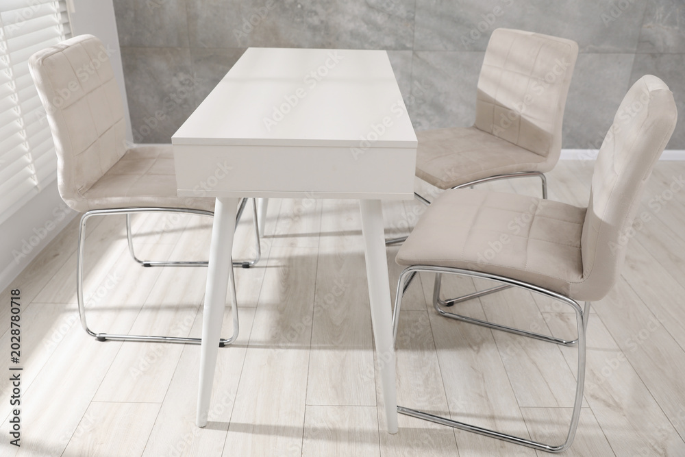 Obraz premium Group of stylish chairs and desk in office