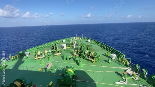 LPG gas and oil tanker ships anchored in the ocean, with a fast patrol boat in the foreground. Global energy transport, war energy crisis, and Strait of Hormuz blockade concept.