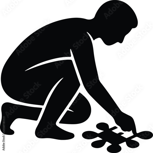 Silhouette vector person crouching and playing with a puzzle piece design