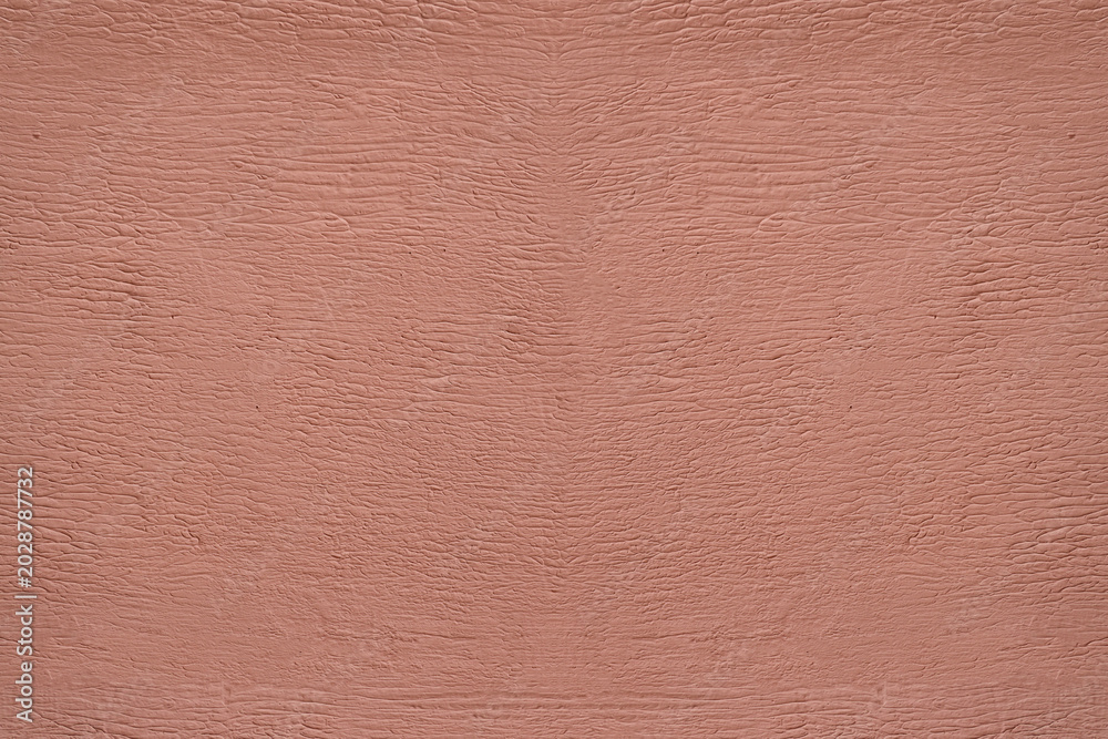 Fototapeta premium red pink plaster wall texture. Seamless surface abstract solid background Pale painted wall built structure textured stucco in terracotta color. seamless texture of plaster backdrop pattern Peach Fuzz