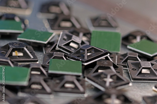 Plastic self-adhesive pad for installing nylon ties.