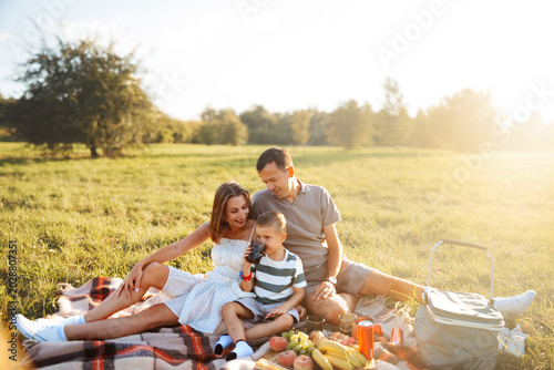 Bild auf Leinwand Happy family sharing peaceful picnic moments under sunlight