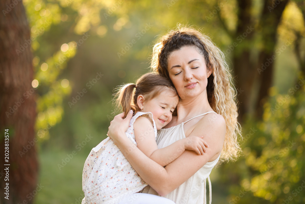 Fototapeta premium Mother with her cute little daughter in nature