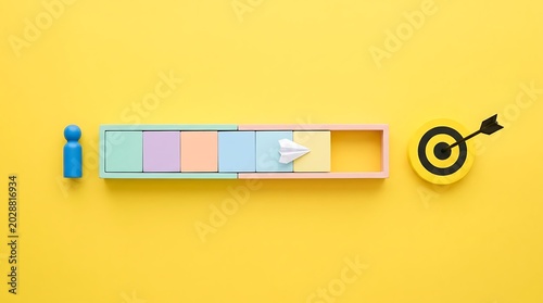 Blue pawn and paper airplane move through colorful blocks towards a target on yellow progress bar