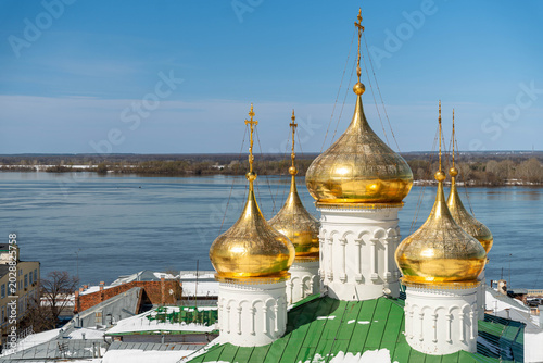 Photos Golden Onion Domes Overlook Icy River, Snowdusted Rooftop With Green Metal Tiles