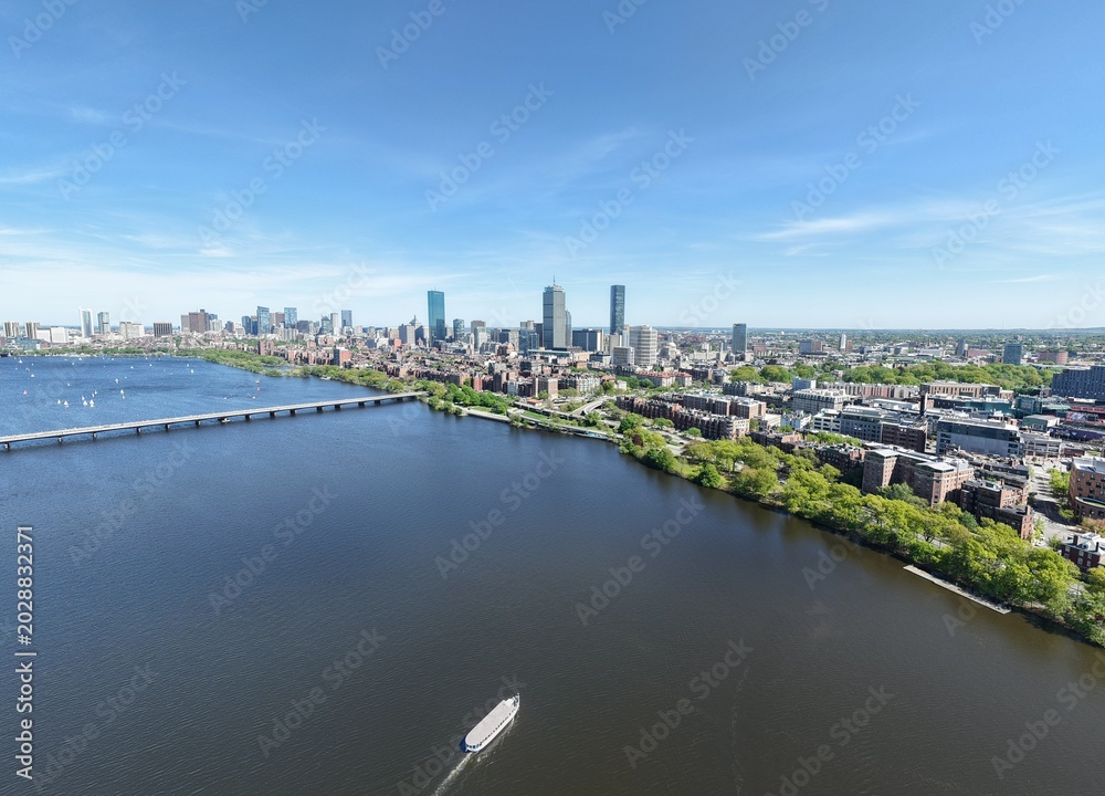 Obraz premium Aerial drone view of Boston Back Bay skyline, Prudential Tower, and Charles River Esplanade on a clear summer day, featuring historic brownstones and city skyscrapers, USA.
