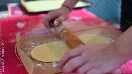Womans Hands Knead Dough with a rolling pin