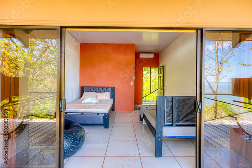 Modern bedroom with ocean view and sliding glass door